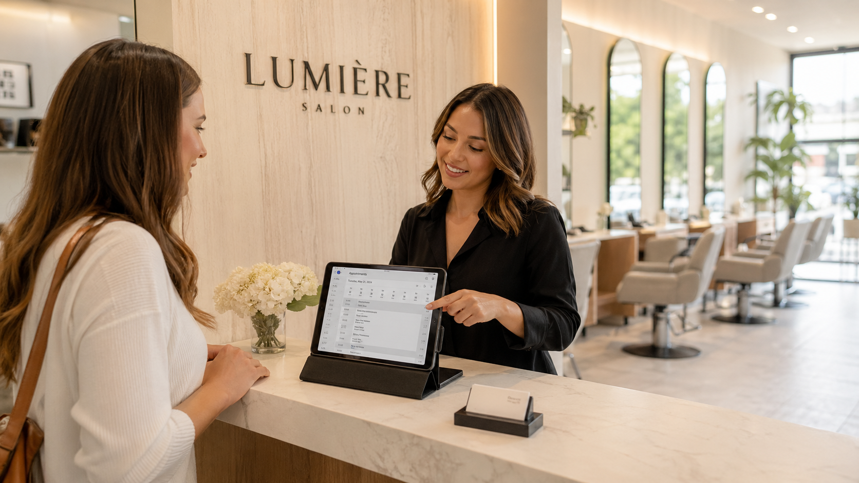 Reception of a service business reviewing bookings on a tablet